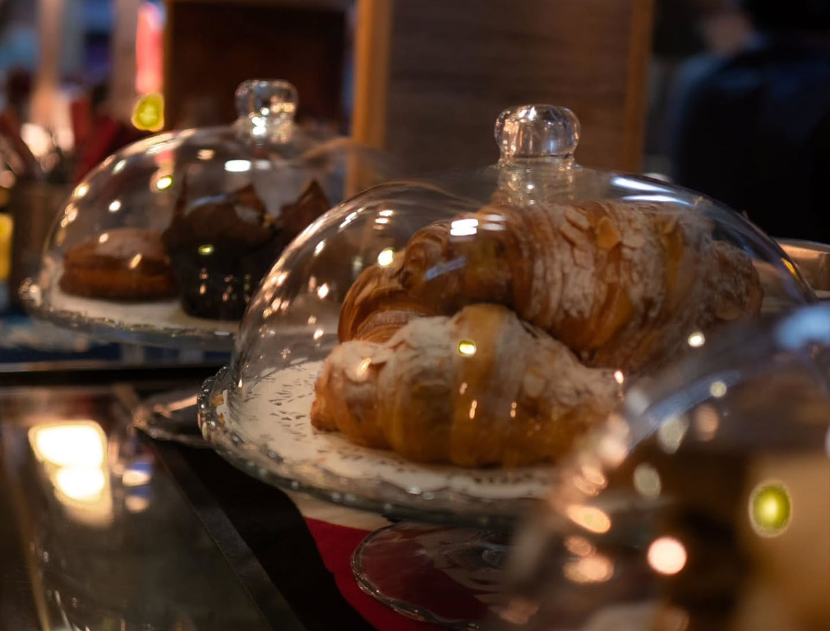 Golden croissants and cardamom buns in the bakery display